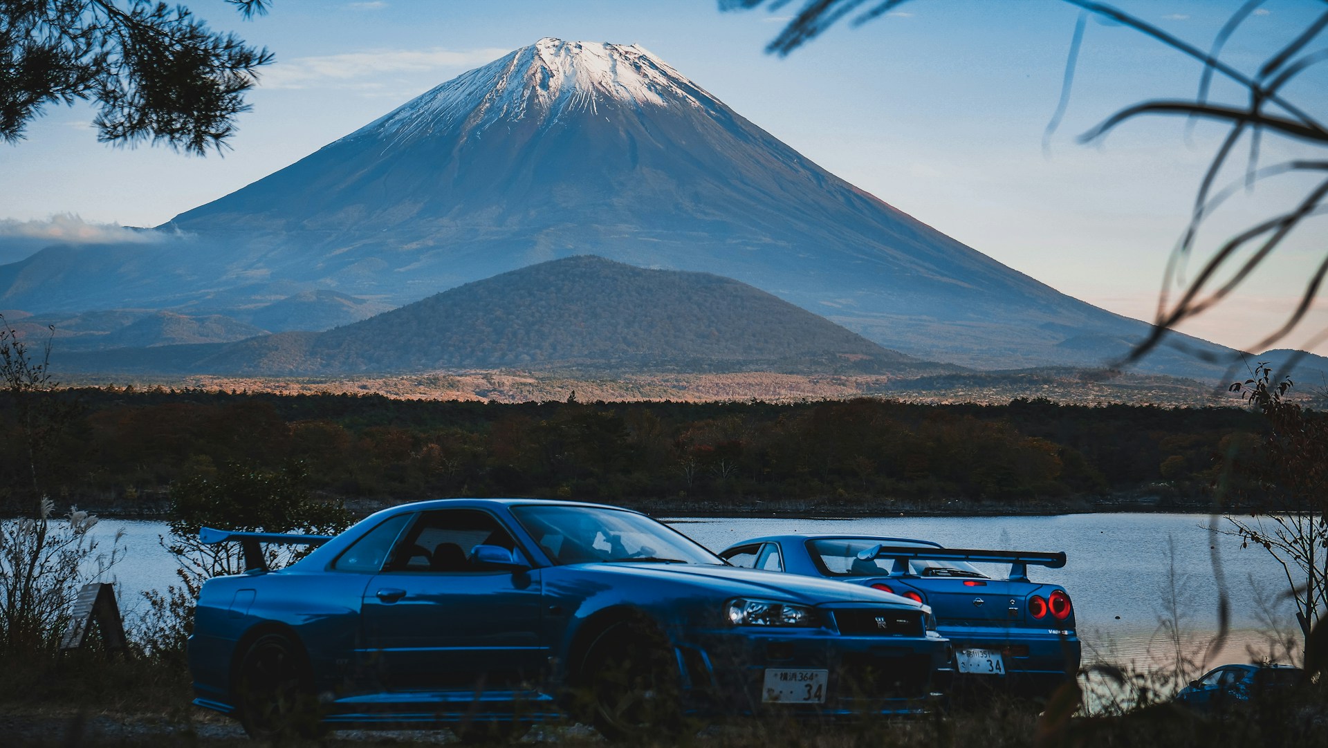 Two R34 GT-Rs in front of Mt Fuji