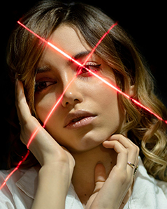 woman with lasers crossed over her left eye