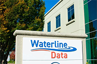 A concrete sign outside a building reads waterline data