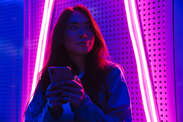 Person in front of neon